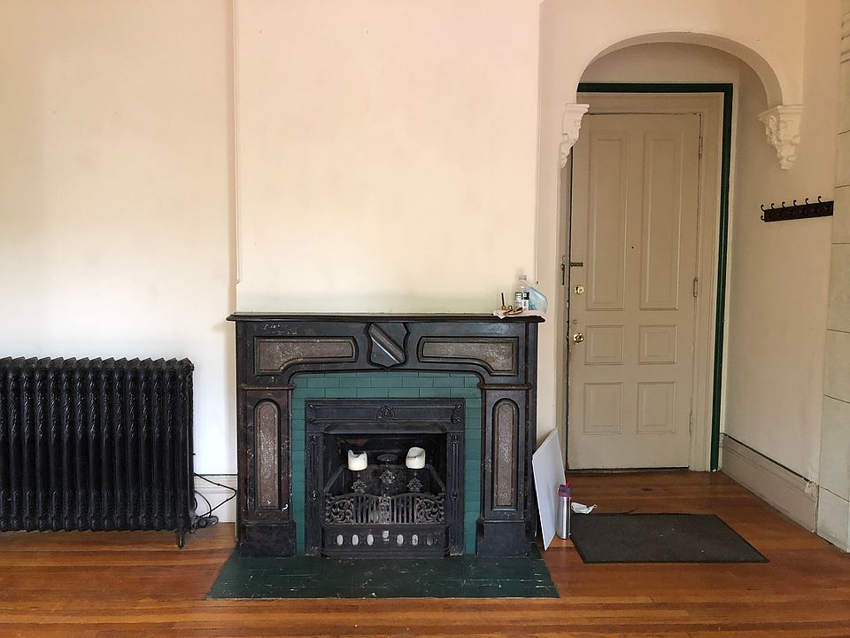 Front door and family room with decorative (non-working) fireplace.