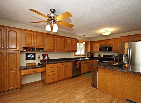 This eat in kitchen space comes with ceiling fan and updated flooring that leads out to your large deck.