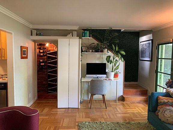 bookcase glides open on hidden tracks to reveal the secret wine cellar / bar within