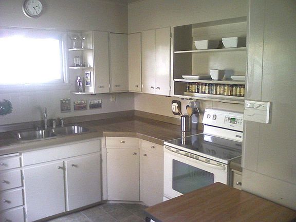 Kitchen with Marble Counters and Stainless Steel Sink and Faucet