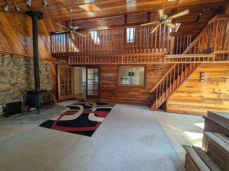 Upstairs hot tub room with fire place and view to the loft