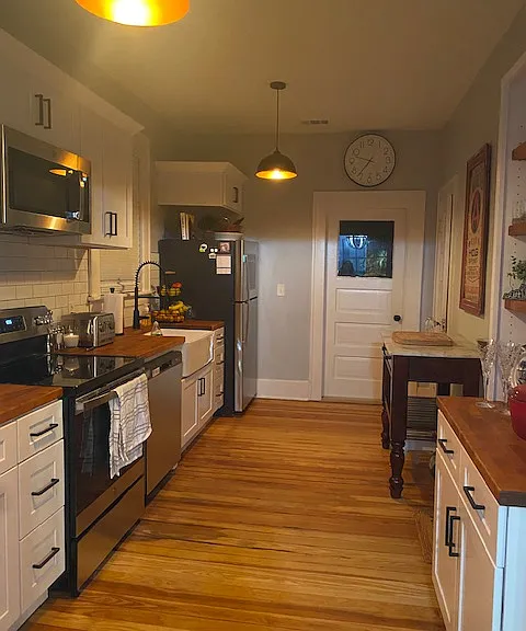 Kitchen: Separate pantry and access to private balcony overlooking back yard and park.