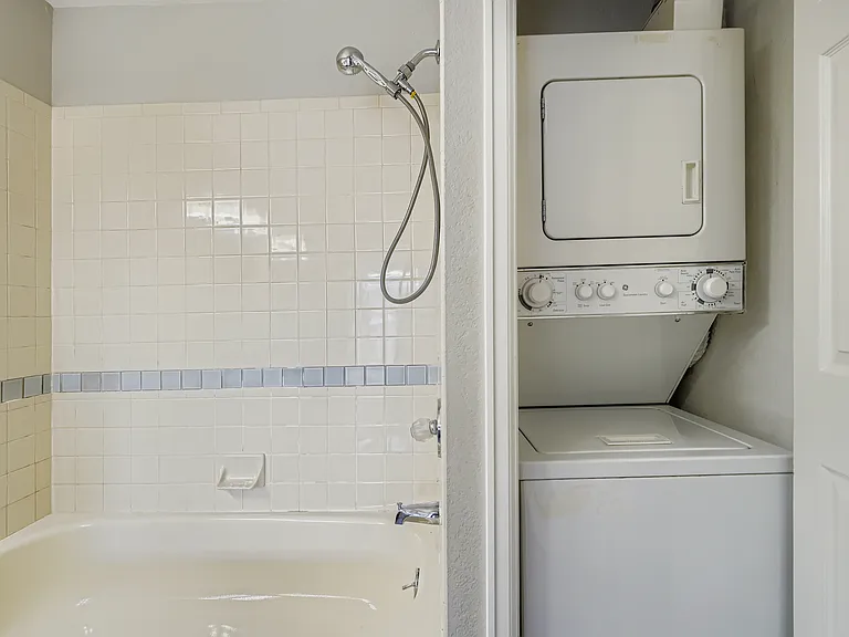 Combo washer/dryer tucks away nicely in the closet. Toilet is behind the camera.