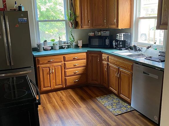 Large kitchen with lots of cupboard space and new stainless steel appliances.