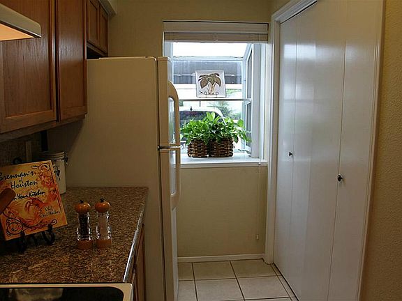 Room for full size washer and dryer behind folding doors in kitchen.