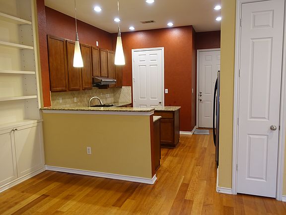 Kitchen with counter seating and granite countertops.