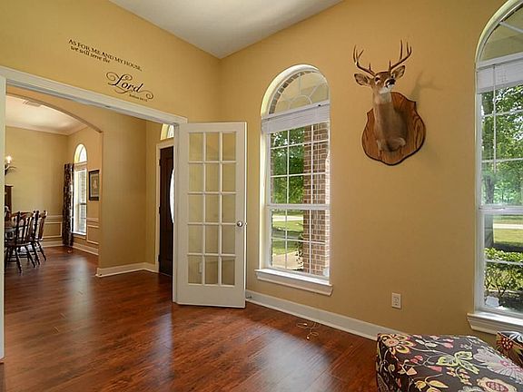  Double French doors open to the Study that is located off the Foyer and offers a matching twin set of Closet doors, ceiling fan and a double set of arched windows