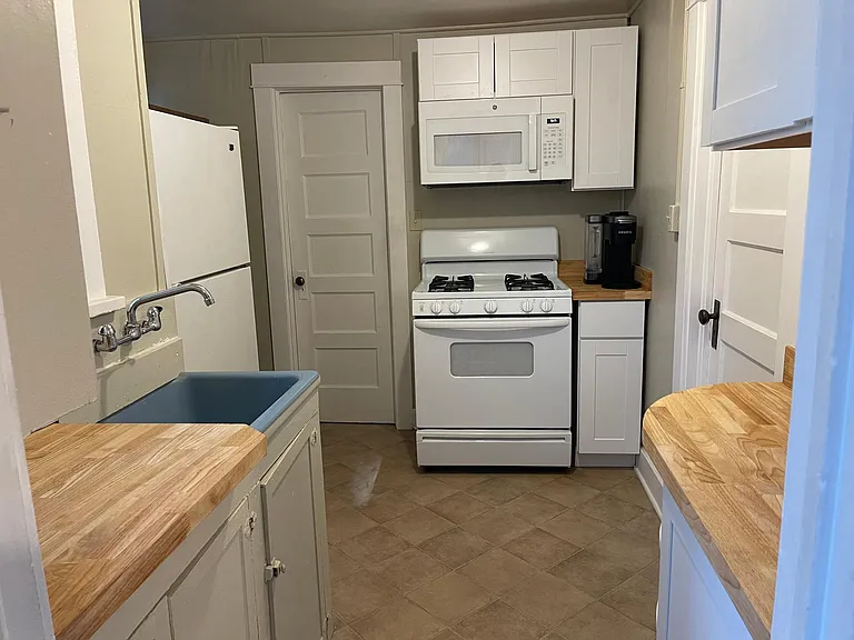 Another view of kitchen with door leading to the bathroom.