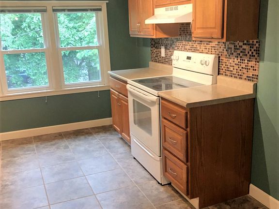 New appliances, cupboards, back splash and flooring