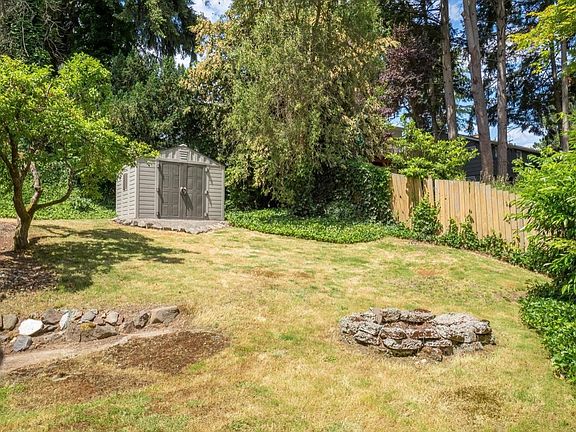 backyard has fire pit and shed