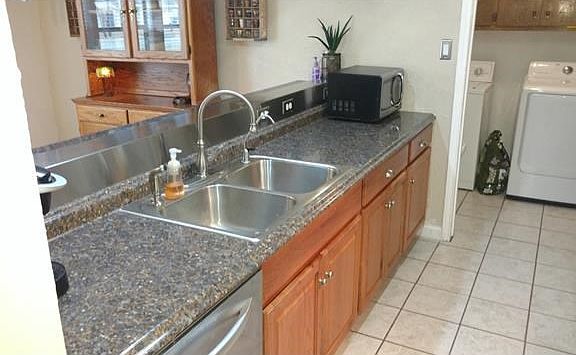 Kitchen Sink Countertop! Note the Bar into the Dining Room and the Recently Updated Countertop, Sink, Faucet, and Stainless Steel Dishwasher!