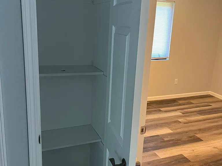 Additional storage outside standard bedroom with shared bathroom.