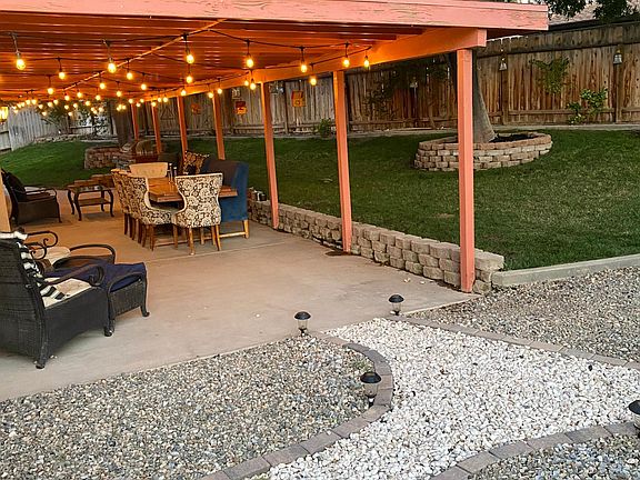 white chipped marble pathway leads to included shed, raised vegetable garden, chicken/dog run, and fire pit.