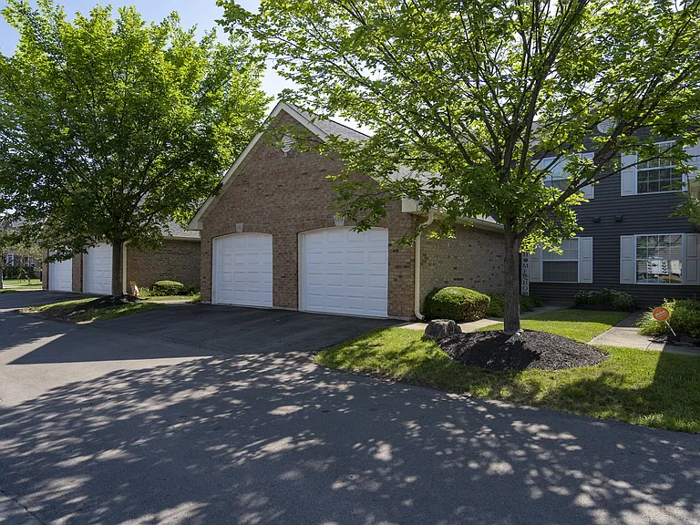 A spacious driveway and tree-lined entrance set the scene for comfort, style, and everyday living.