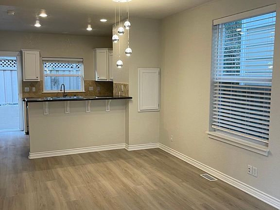 living room with new flooring and new chandelier