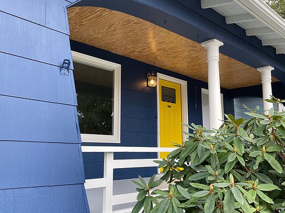 Front porch is expansive with natural wood ceiling. Because it's covered it's great to use year-round.