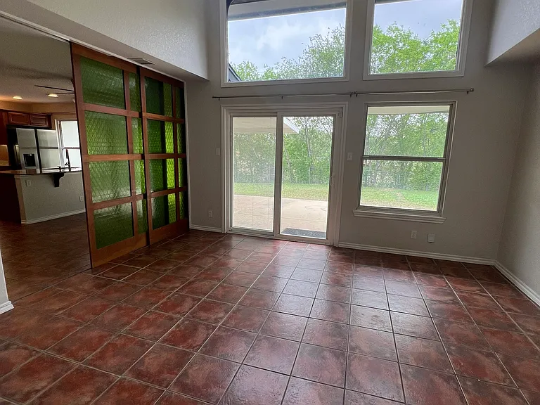 View of living room and built in sliding room partition.