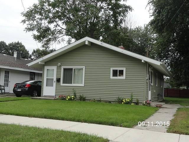 Green siding with white trim.
