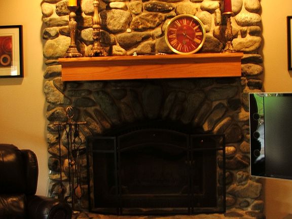 Great wood burning fireplace decked out with river rock