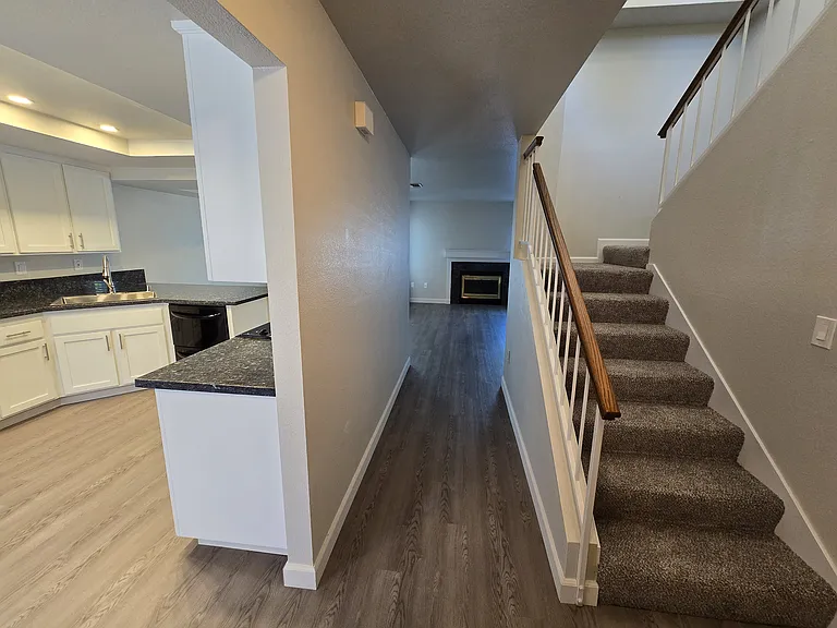 Welcoming entry opens to a beautifully remodeled interior with luxury plank flooring, custom staircase, and an open-concept floor plan.