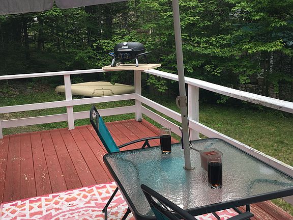 back patio complete with bbq and umbrella for the summer months