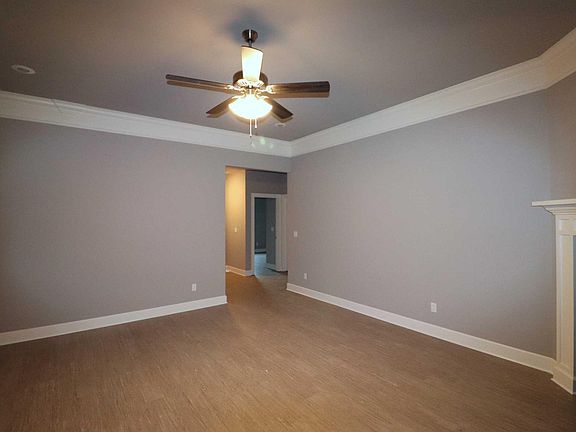 Living room with ceiling fan and gas fireplace