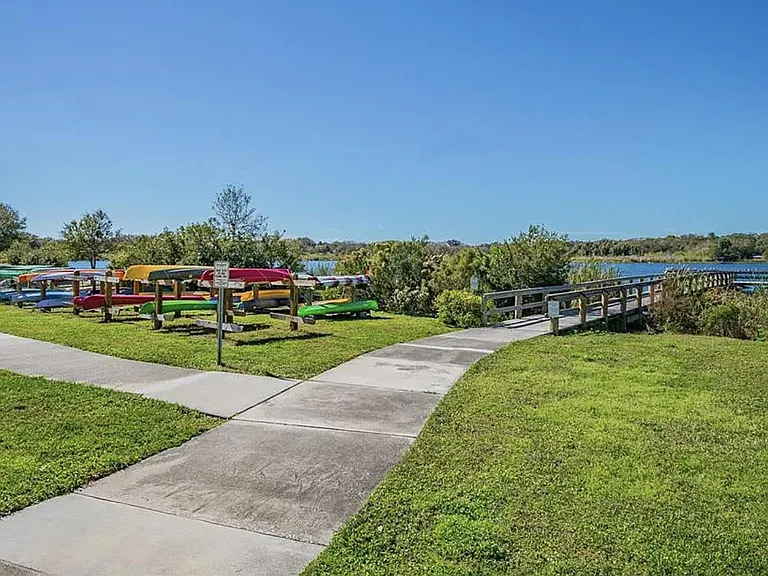 Walkway to lake with small boat storage