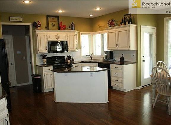 The  open and bright kitchen is a cook's dream with granite counters, newer stove with double oven, microwave and a brand new dishwasher.