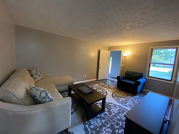 Upper level living/dining area. Stairs to lower level. Door leads to common entry area.
