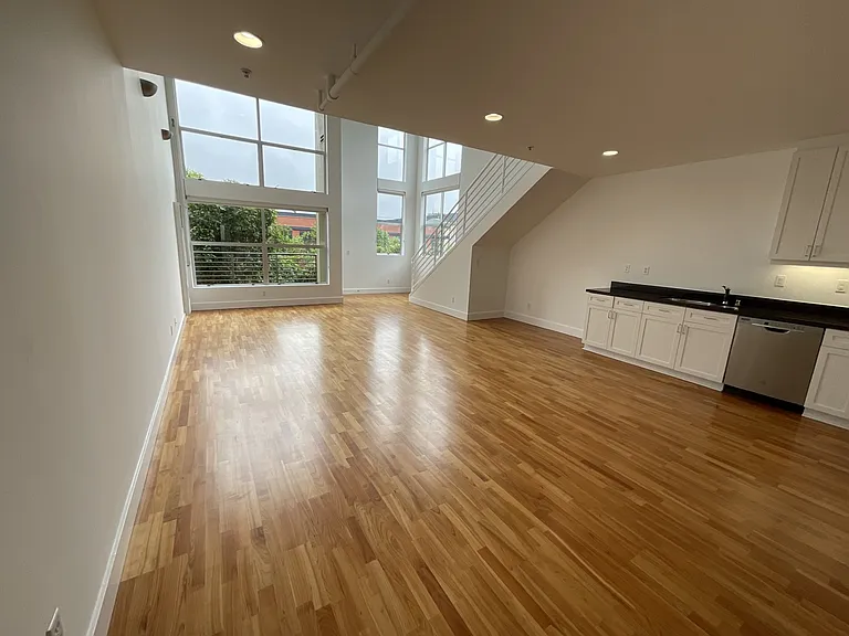 Open kitchen and living room area with patio off the living room overlooking Alabama Street.