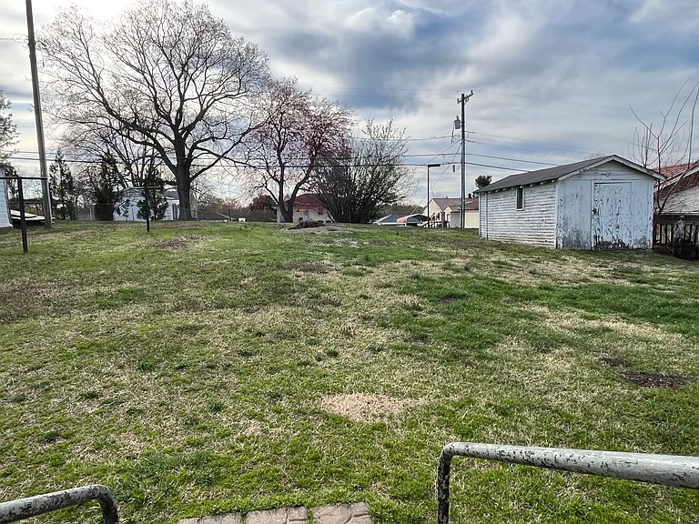 Large rear yard with a storage building.