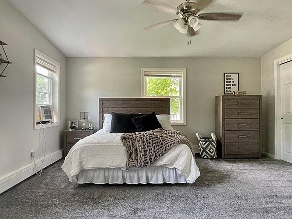 Bedroom view from the stairwell. Three windows surround the room and brighten it up. The ceiling is also cathedral and very open.