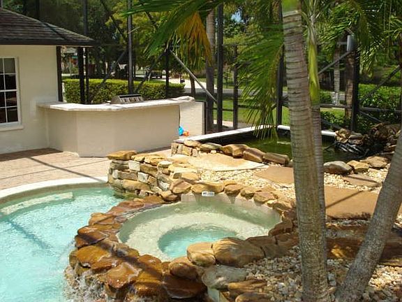 view from waterslide looking at spa, koi pond and BBQ area