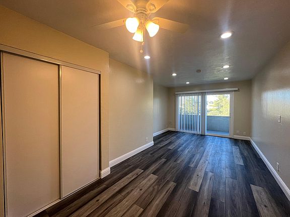 Spacious Living Room with Sliding Glass Doors to Private Balcony and New Luxury Flooring