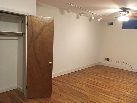 Showing the coat closet in the living room with the ceiling track lights