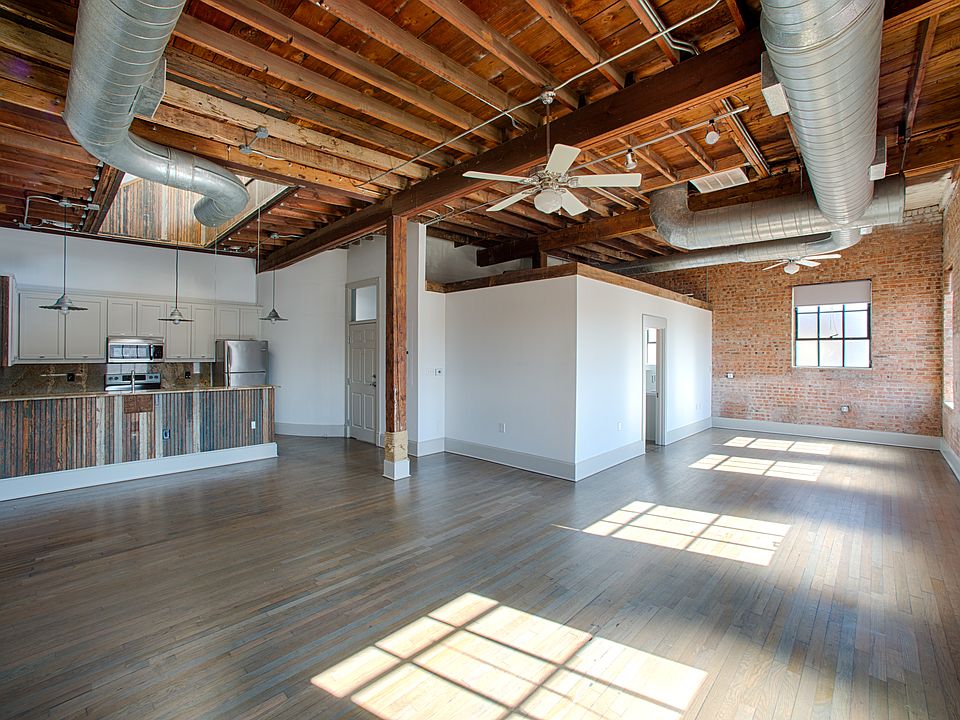 True studio apartment with exposed brick and vaulted ceilings