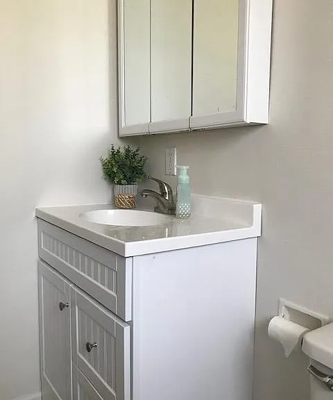 Mirrors in the medicine cabinet can be adjusted to show more than a front on image.