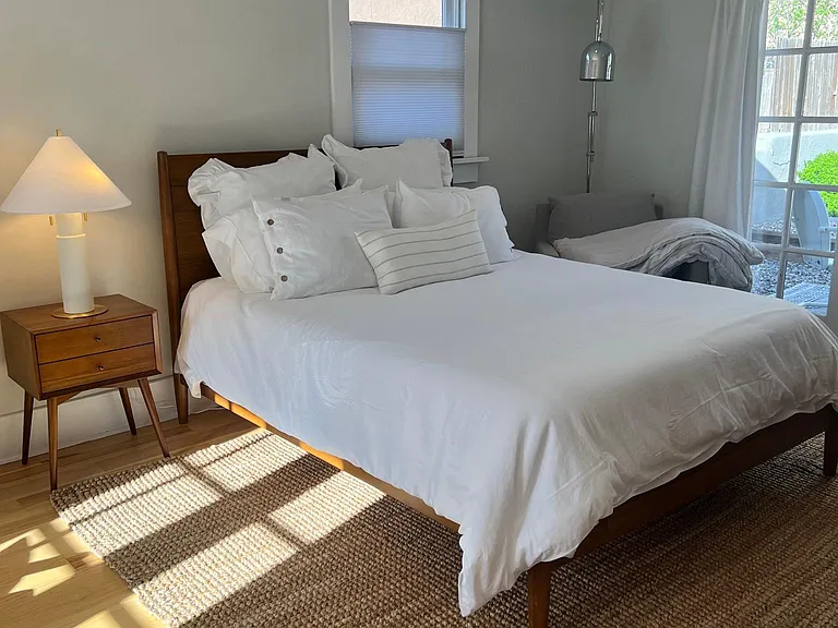 Bedroom with storage and 50' TV, including internet access, streaming services included are YouTube TV, Netflix and Amazon Video.