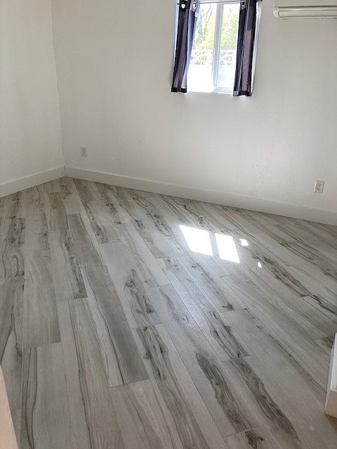 Master bedroom with King Size bed and two end tables with ceiling fan.
