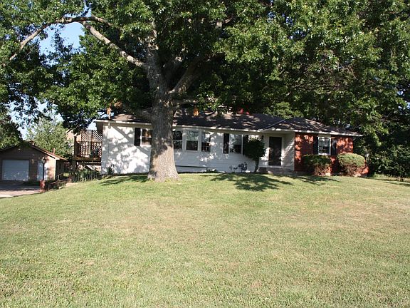 Raised Ranch home with 2 car garage in unfinished basement. 1+ car detached garage.