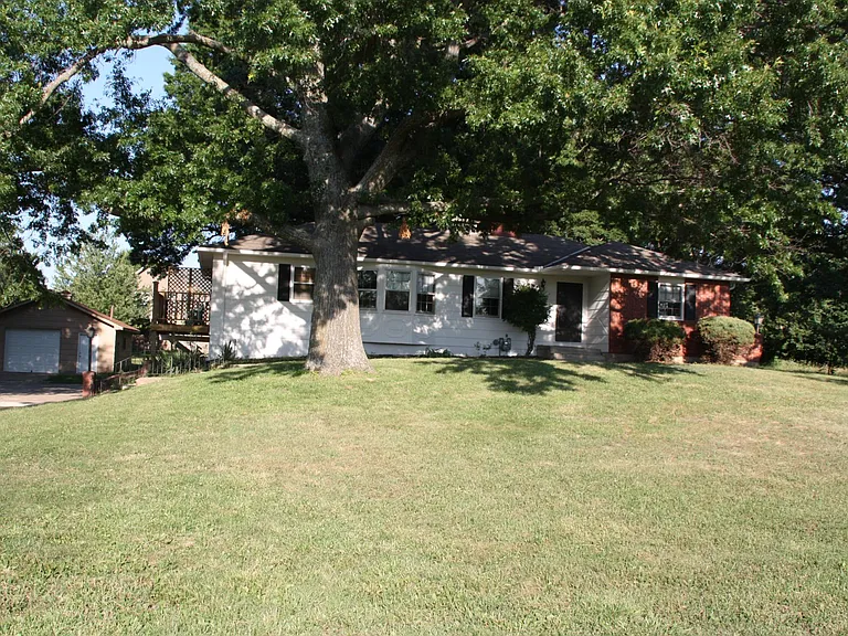 Raised Ranch home with 2 car garage in unfinished basement. 1+ car detached garage.