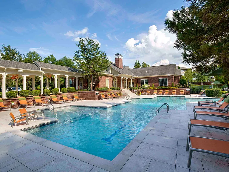 Resort-style pool and expansive sundeck with lounge seating