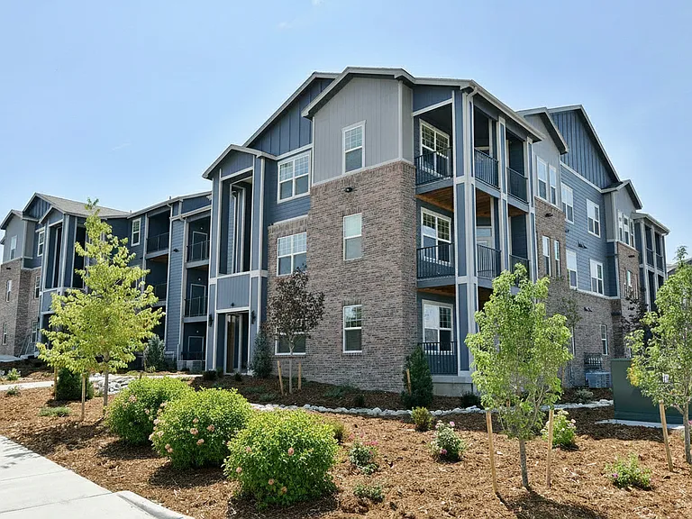 Christine Place building exterior. Private balconies and well-maintained landscaping