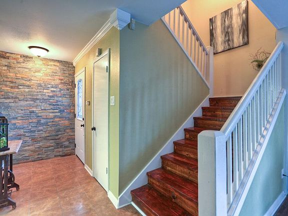 Entry features slate lined wall and spacious coat closet on the right by front door.