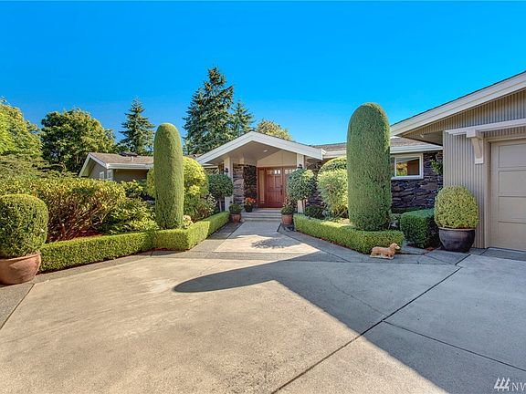 1958 mid century modern home tastefully updated. Lovely landscaping, two car garage plus extra parking for multiple vehicles.