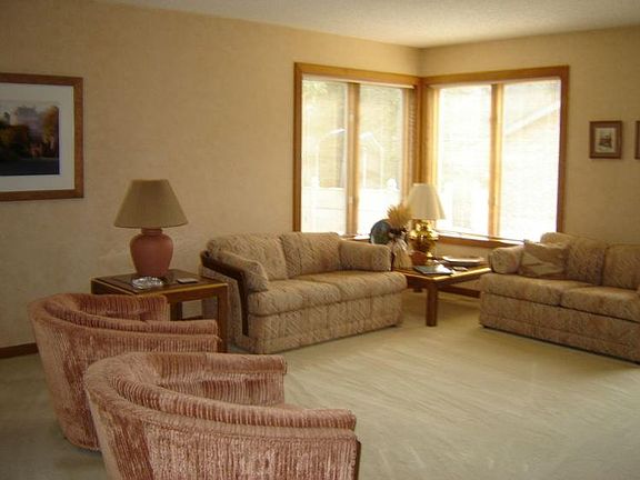 br /A few steps up and you are in the Living Room.........there are several large windows in this room also.