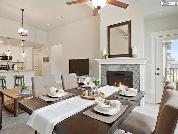 Open floorplan with fireplace and mountain view from patio