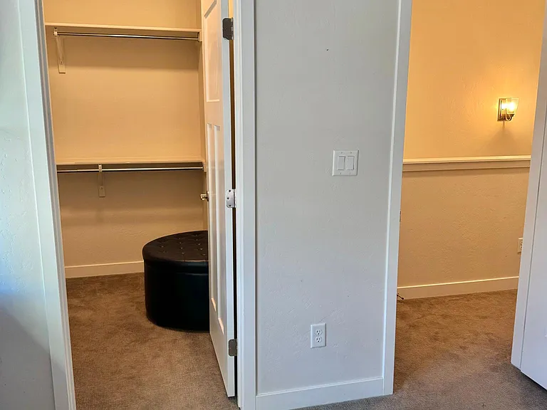 Primary bedroom closet left and hallway right