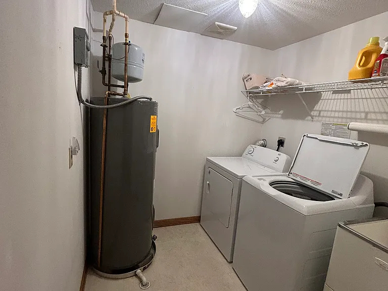 Laundry room with basin tub. Washer and dryer stay