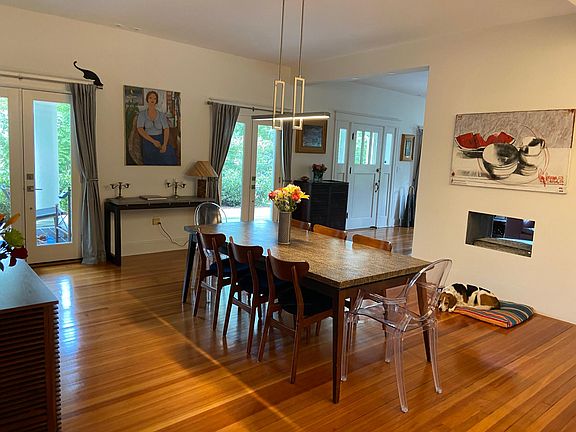 Dining room opening to living room with double sided fireplace